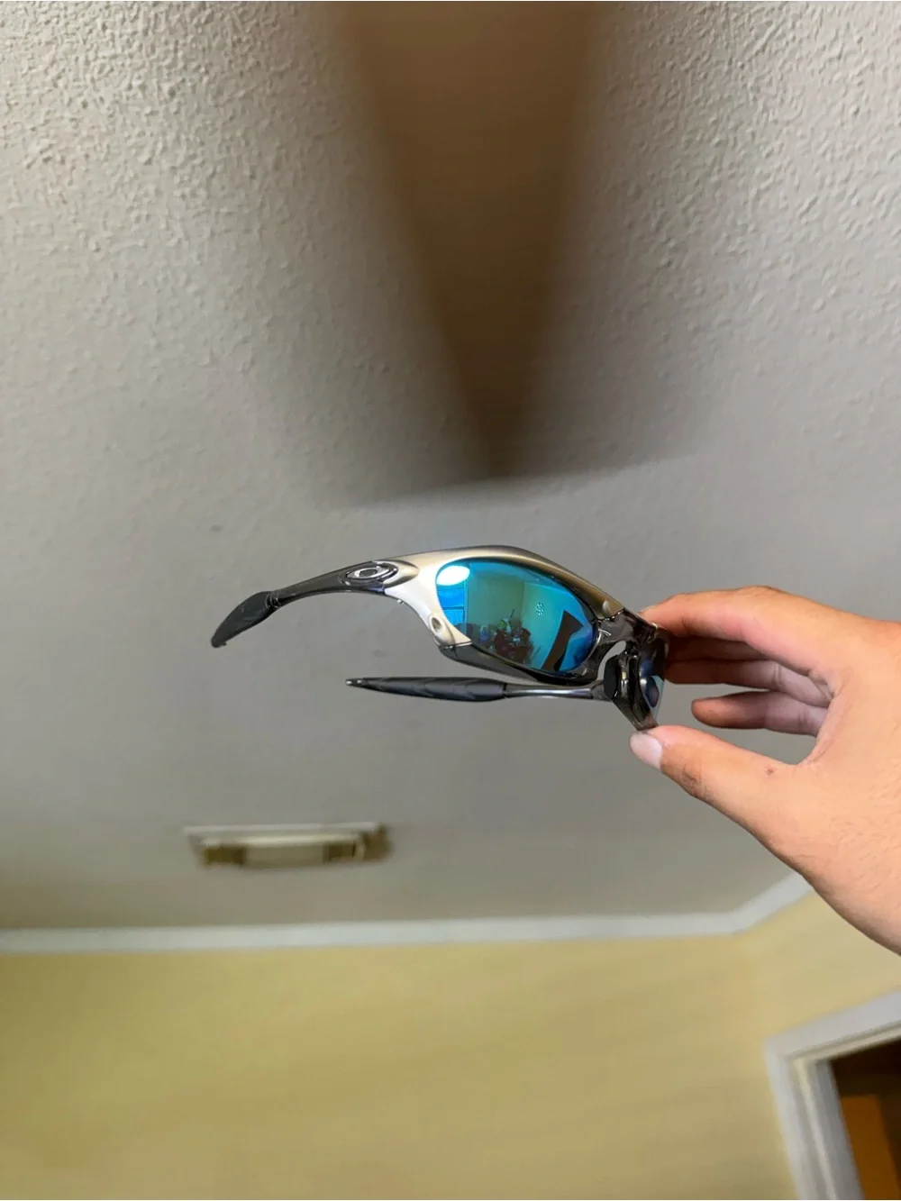 Oakley Silver Frame Sunglasses with Blue-Green Mirrored Lenses